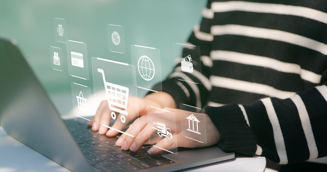 Woman or Shopper using a laptop computer with shopping cart and business icon